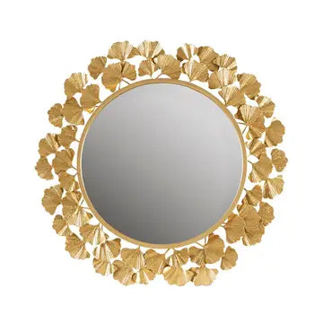 Decorative gold mirror with floral patterns on a white background