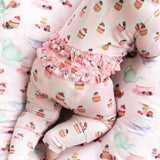 Children's pajama set with cupcake pattern on a soft pink background