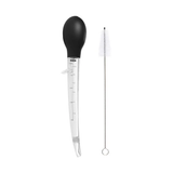 An angled baster with a black bulb and clear measurement markings, accompanied by a metal cleaning brush.