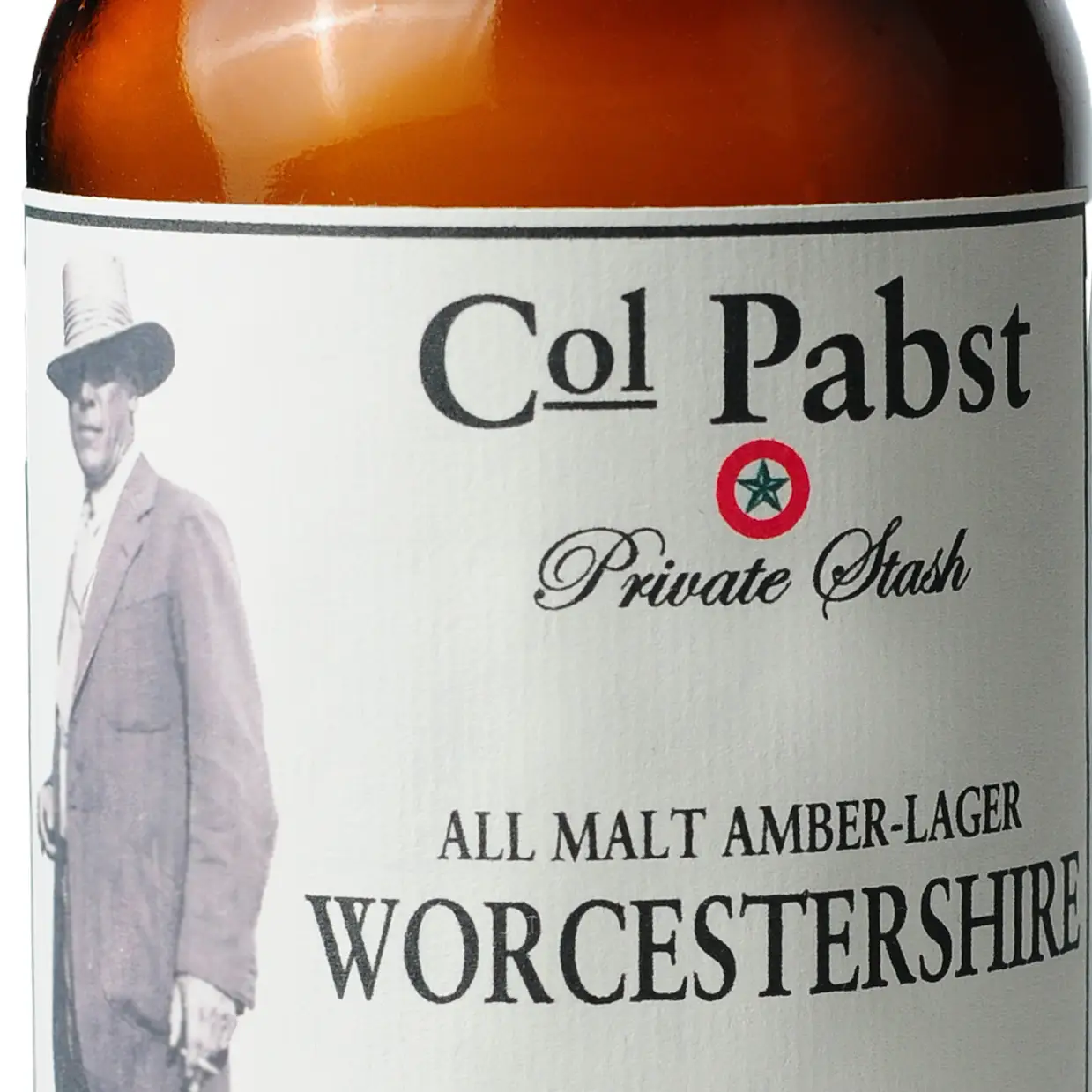 A bottle of Colonel Pabst Worcestershire sauce with a label featuring an illustration of a man in a hat and a star, indicating the brand and possibly the chef or founder associated with the product.