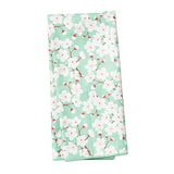 Floral patterned towel with cherry blossoms on a light green background