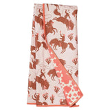 Folded towel with cowboy and horse pattern on a white background