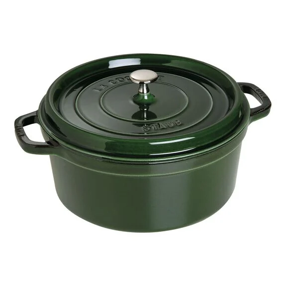 Green staub cast iron pot on white background