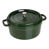 Green staub cast iron pot on white background