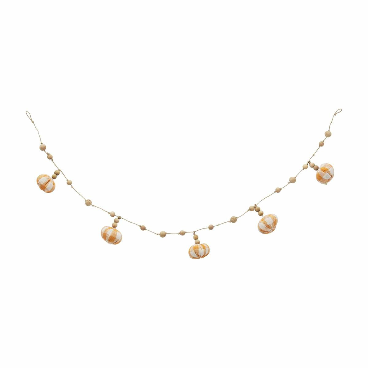 A buffalo beaded pumpkin garland with gold-colored beads and pumpkin-shaped decorations.