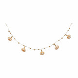 A buffalo beaded pumpkin garland with gold-colored beads and pumpkin-shaped decorations.
