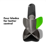 A black and gray OXO avocado tool with a curved edge for scooping and a flat side for mashing, featuring a green and white label that says 'FOUR BLADES FOR BETTER CONTROL'.