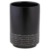 A black cylindrical mason crock with a textured pattern, used for holding kitchen utensils.