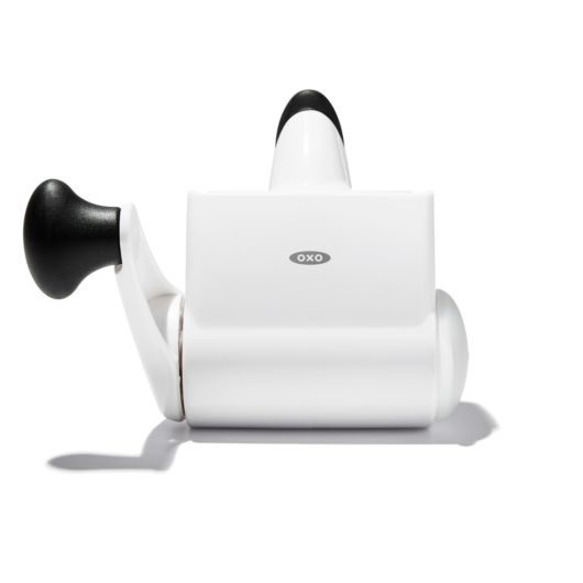 A white OXO rotary grater with a black handle and a non-slip base.