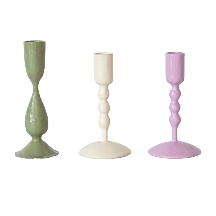 Three colorful candle holders on a white background