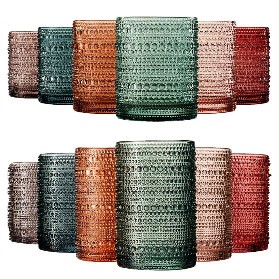Set of colorful textured glass tumblers on a white background