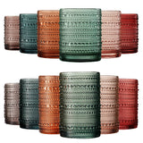 Set of colorful textured glass tumblers on a white background