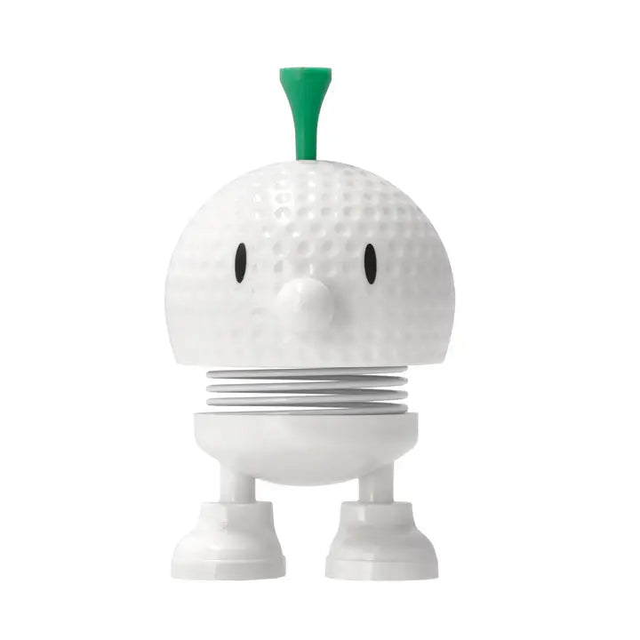 White robot-like figure with a green top on a white background
