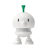 White robot-like figure with a green top on a white background