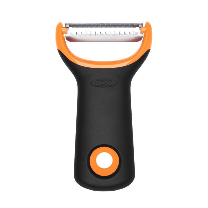 A black and orange OXO julienne prep peeler with a metallic blade.