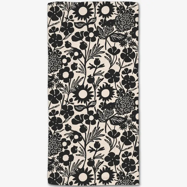 Floral patterned fabric with black flowers on a white background