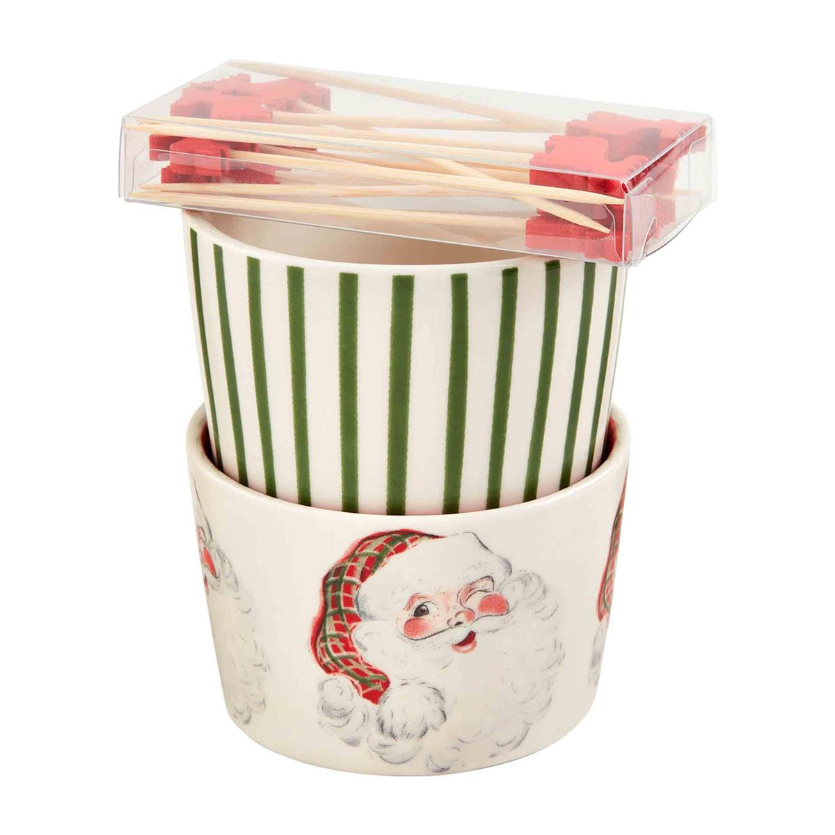 A set of Christmas-themed serving dishes with a Santa Claus design, including a bowl and cups with green striped patterns.