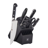 A black knife block with a wood compartment, containing a knife and a pair of scissors. The block is labeled with the Zwilling brand logo.