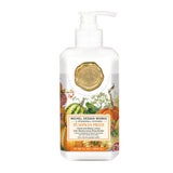 A pump bottle of Michel Design Works Pumpkin Lotion with a decorative design featuring pumpkins and autumn-themed illustrations.