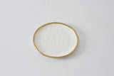A round salad plate with a gold finish on the edge, displayed against a white background.