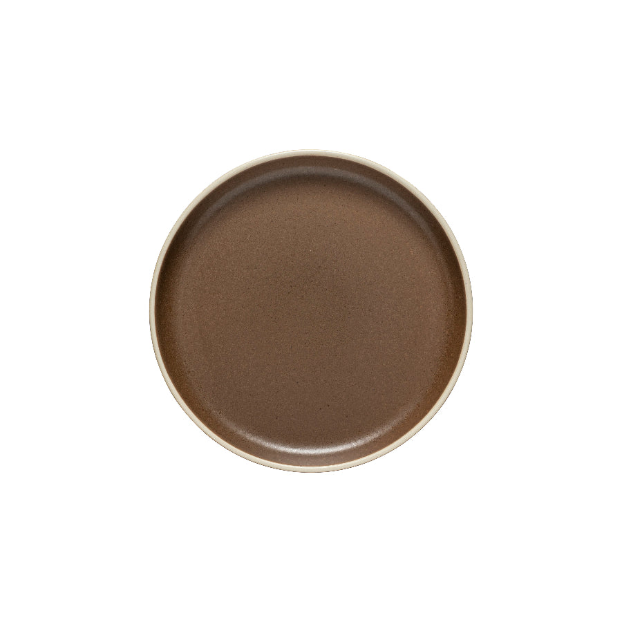 A round, brown salad plate made of ceramic.