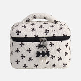 White cosmetic bag with black butterfly patterns on a white background
