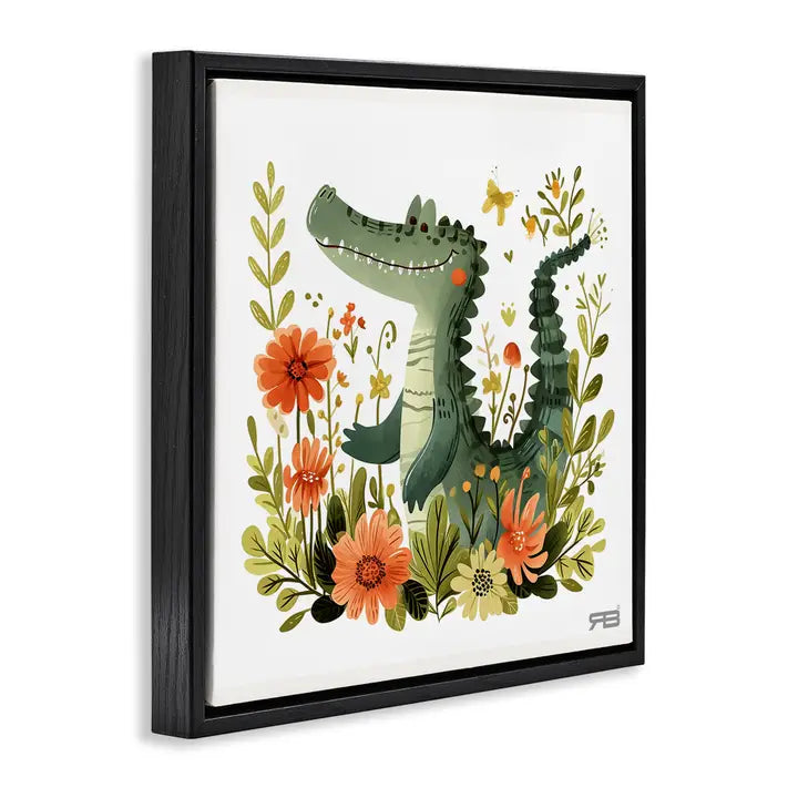 Framed wall art featuring a whimsical green alligator surrounded by orange flowers and green leaves on a white background, shown in a black floating frame against a light gray wall.