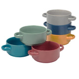 Set of colorful ceramic bowls stacked on a white background