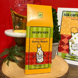 Ala Carte Alice Shrimp Bisque packaging on a wooden surface with a red background