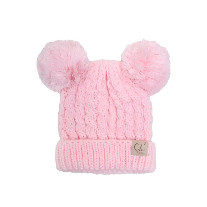 Pink knit beanie with two pom-poms on a white background