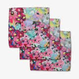 Set of three floral patterned towels on a white background