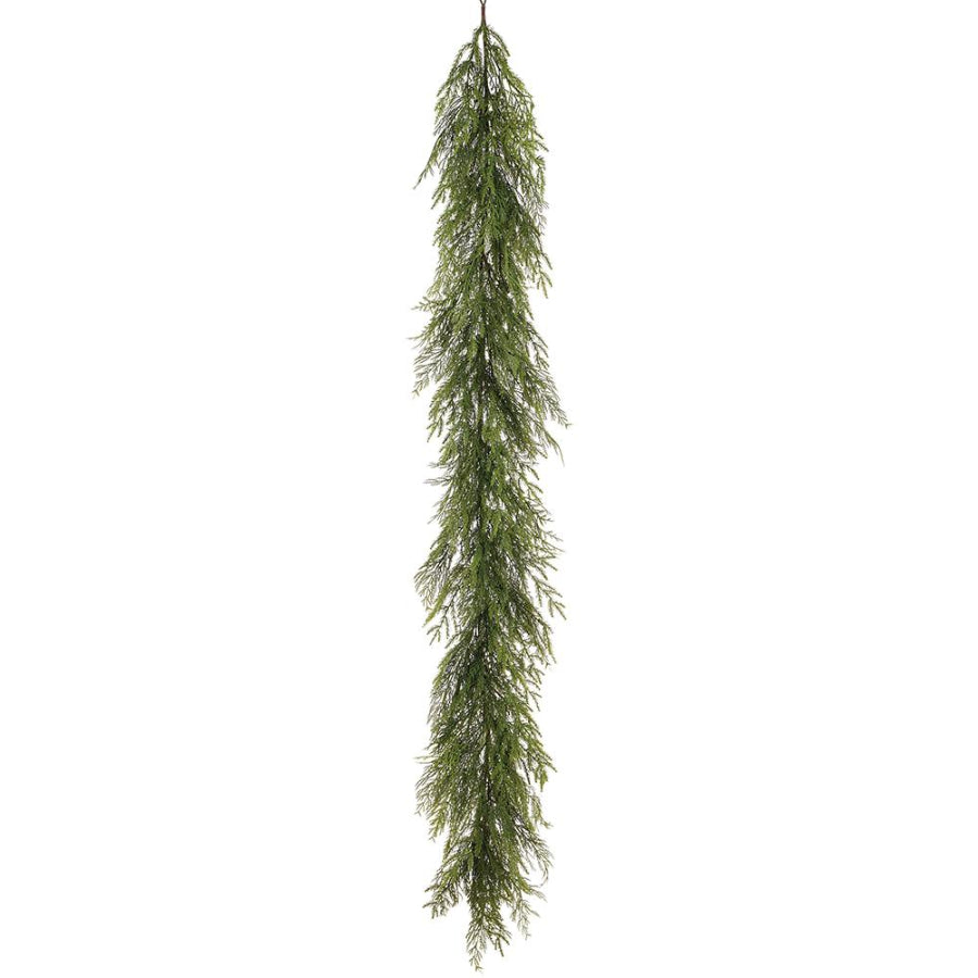 Long, green artificial Christmas garland on a white background