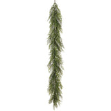 Long, green artificial Christmas garland on a white background