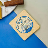 Block of cheese with a 'Cheese Brothers Reserve' label on a blue surface