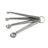 A set of four stainless steel measuring spoons with dashboard handles, labeled with measurements.