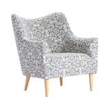 A floral patterned arm chair with a wooden frame and legs, upholstered in a blue and white fabric.