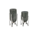 A pair of cylindrical marble vases with metal accents, one larger than the other, placed against a white background.