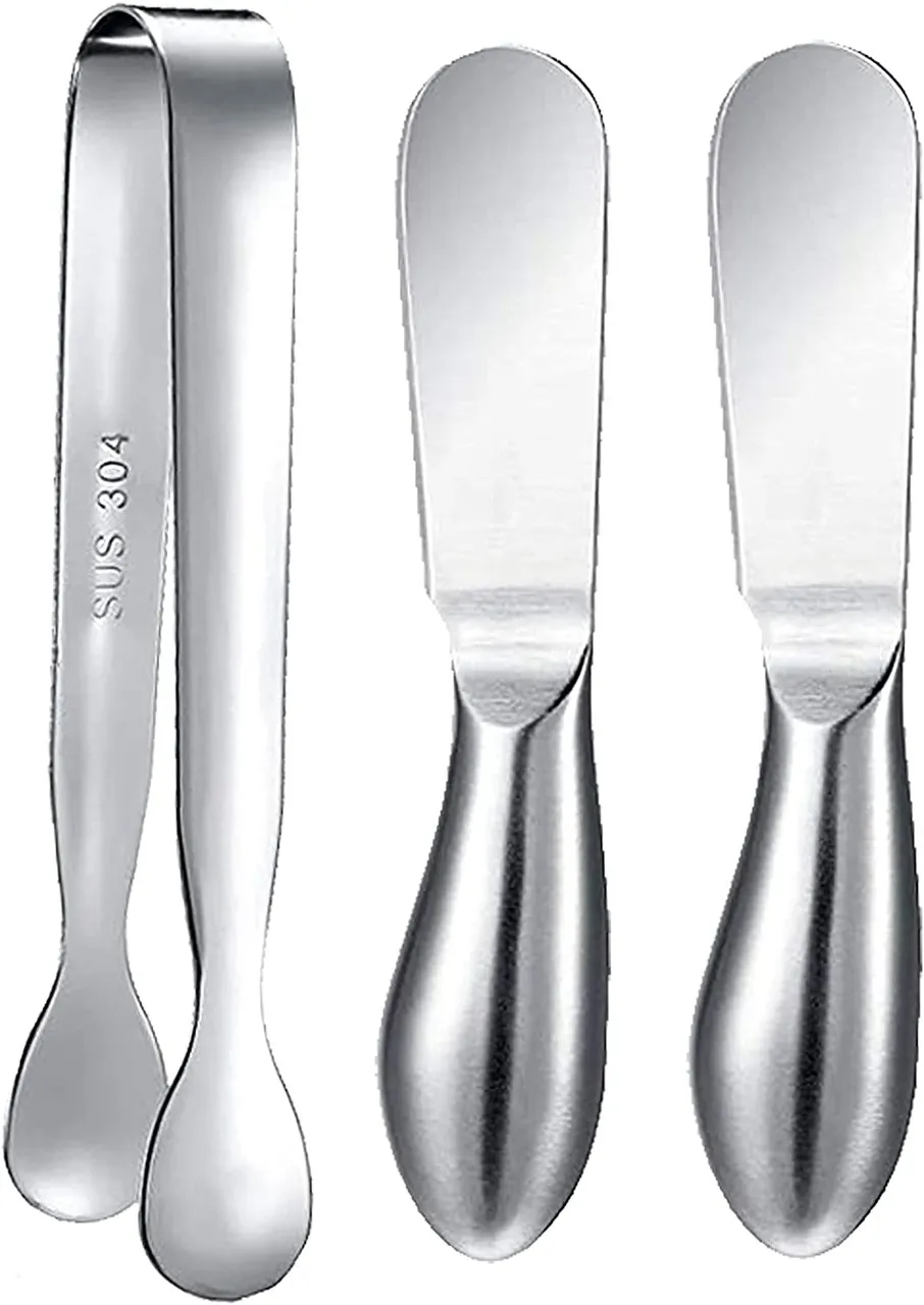 A 3-piece charcuterie set including a cheese knife, a spread knife, and a pair of tongs, all with stainless steel handles.