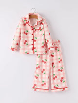 Pink pajama set with cherry pattern on a white background