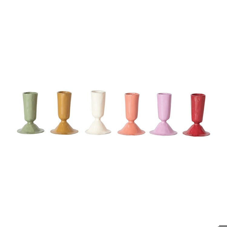 Set of six colorful candle holders on a white background