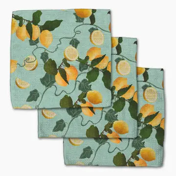 Three square cotton napkins with a lemon and leaf pattern on a light blue-green background, arranged in an overlapping stack on a white background.