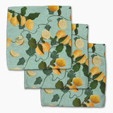 Three square cotton napkins with a lemon and leaf pattern on a light blue-green background, arranged in an overlapping stack on a white background.