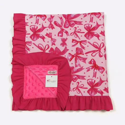 Pink baby blanket with bow pattern on a white background
