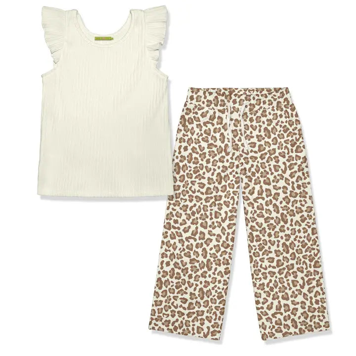 White sleeveless top with ruffled sleeves and leopard print pants on a white background