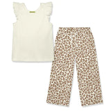 White sleeveless top with ruffled sleeves and leopard print pants on a white background