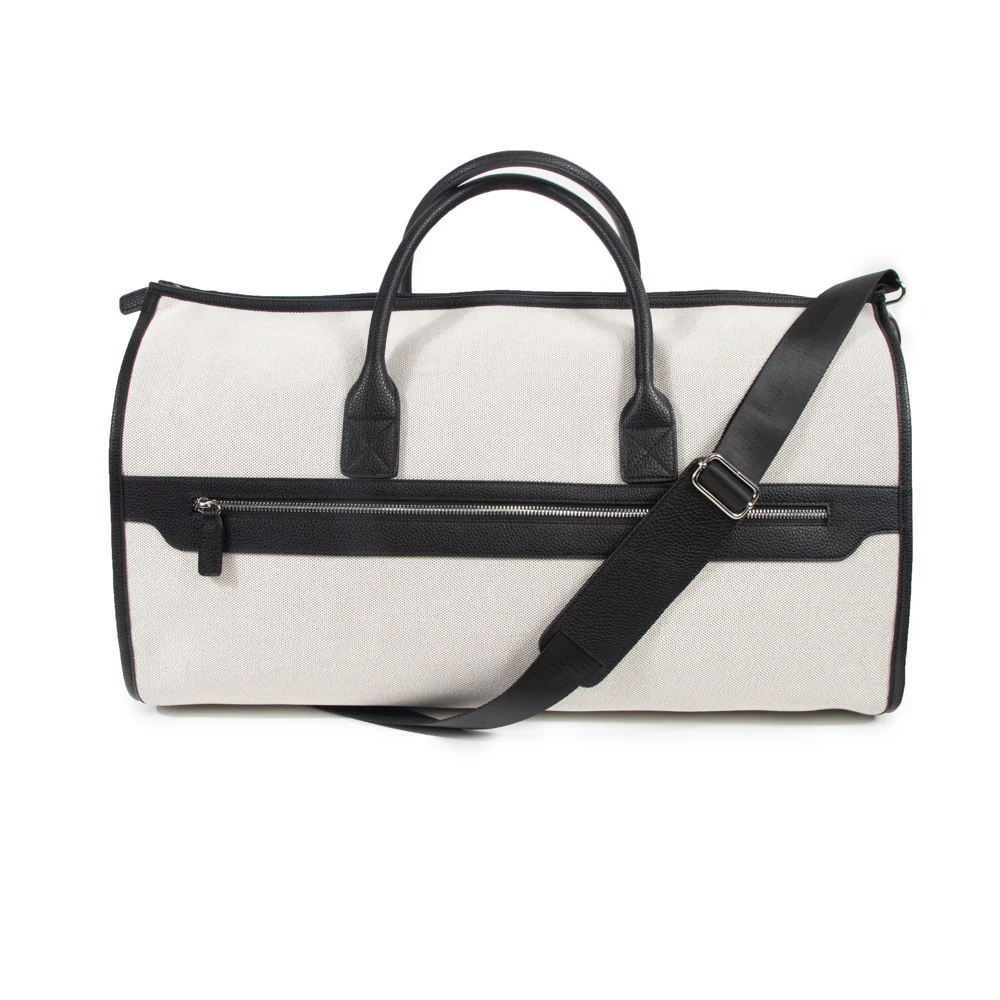 A black and white Capri 2-in-1 garment bag with vegan leather accents, featuring a shoulder strap and carry handles.