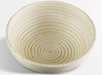 Round woven bread basket with concentric circles on a white background
