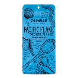 A blue package of Olivelle Pacific Flake Kosher Sea Salt with illustrations of shells and text depicting the product details.