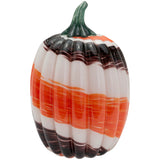 Decorative glass pumpkin with orange, white, and black stripes on a white background