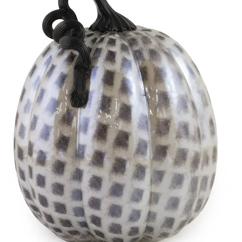 Decorative pumpkin with black and white checkered pattern on a white background